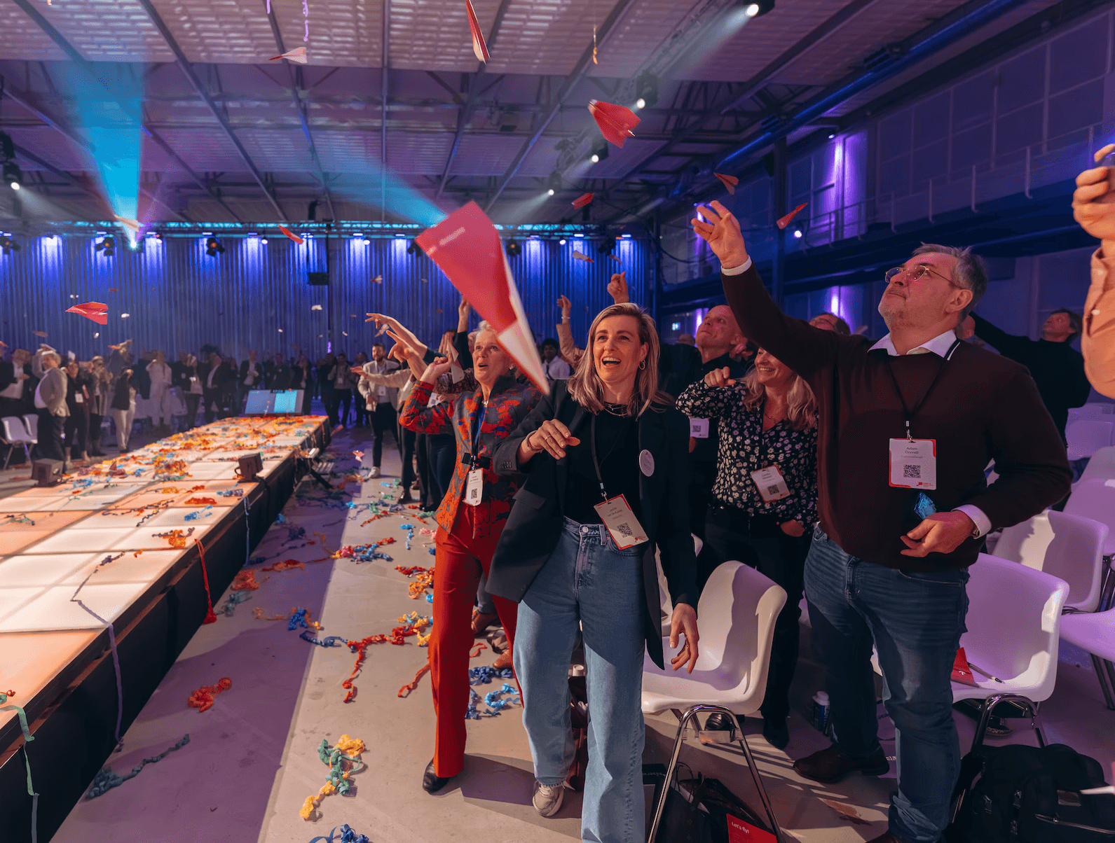 People throwing suggestions as paper airplaines in the air