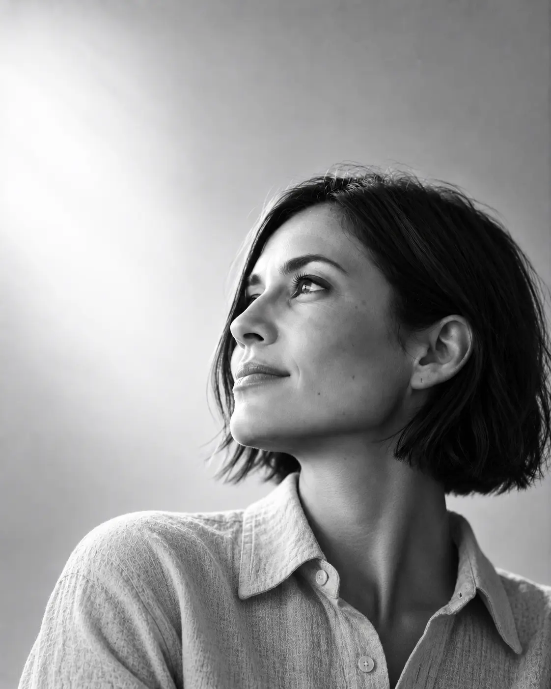 Teodora Vasile, equity compensation advisor, with a dark bob and a pale linen shirt, looking up and to the left