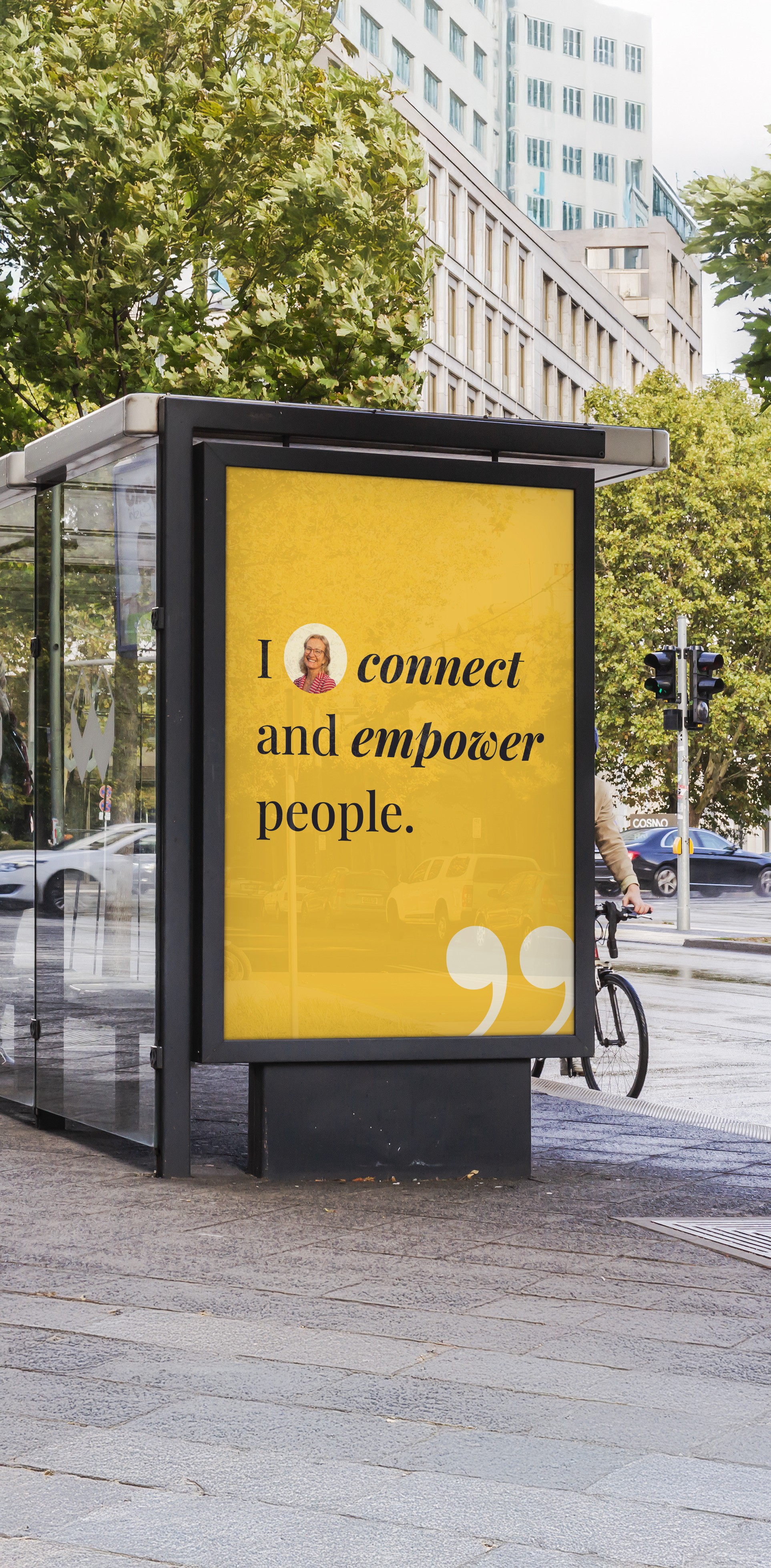 Poster at bus stop that says "I (Image of Alex) connect and empower people."