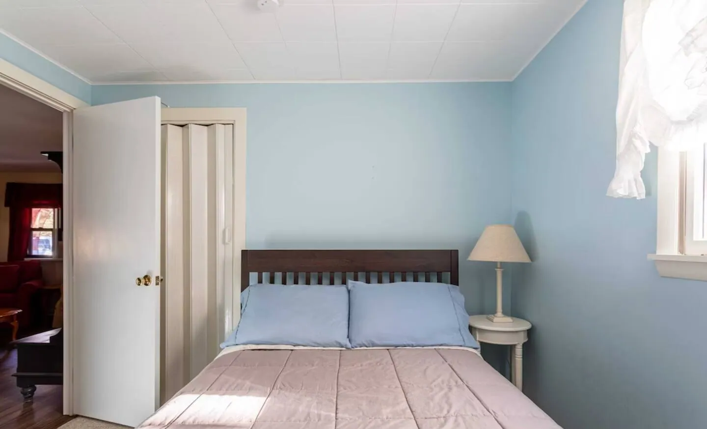 Light blue bedroom with full bed and lamp at Relax in Style