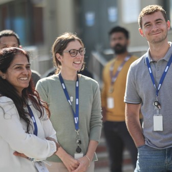 Photo of a group of staff outside in the sun earing CPI lanyards