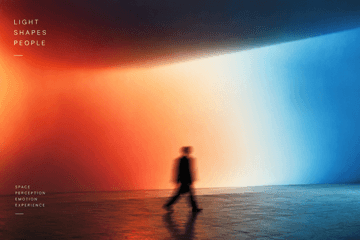 A figure walks past a wall of gradient light