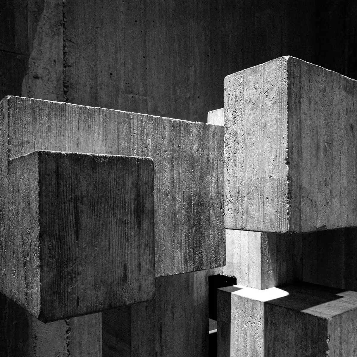 Abstract concrete blocks stacked together, symbolising strong structural foundations and long-term stability.
