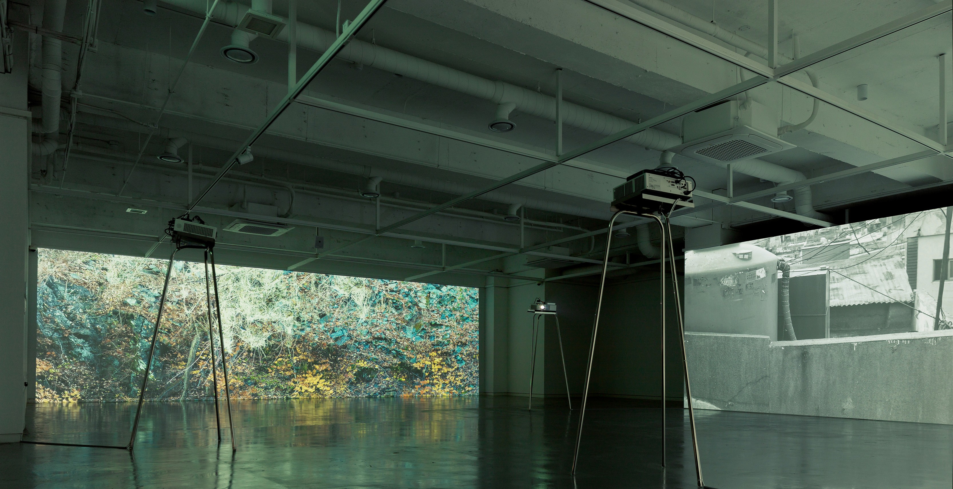 Close-up of model in orange and black outfit behind glass