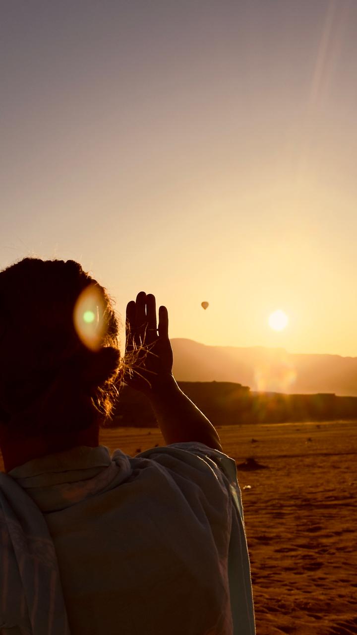 Guest looking at a sunset with a Balloon in the distance