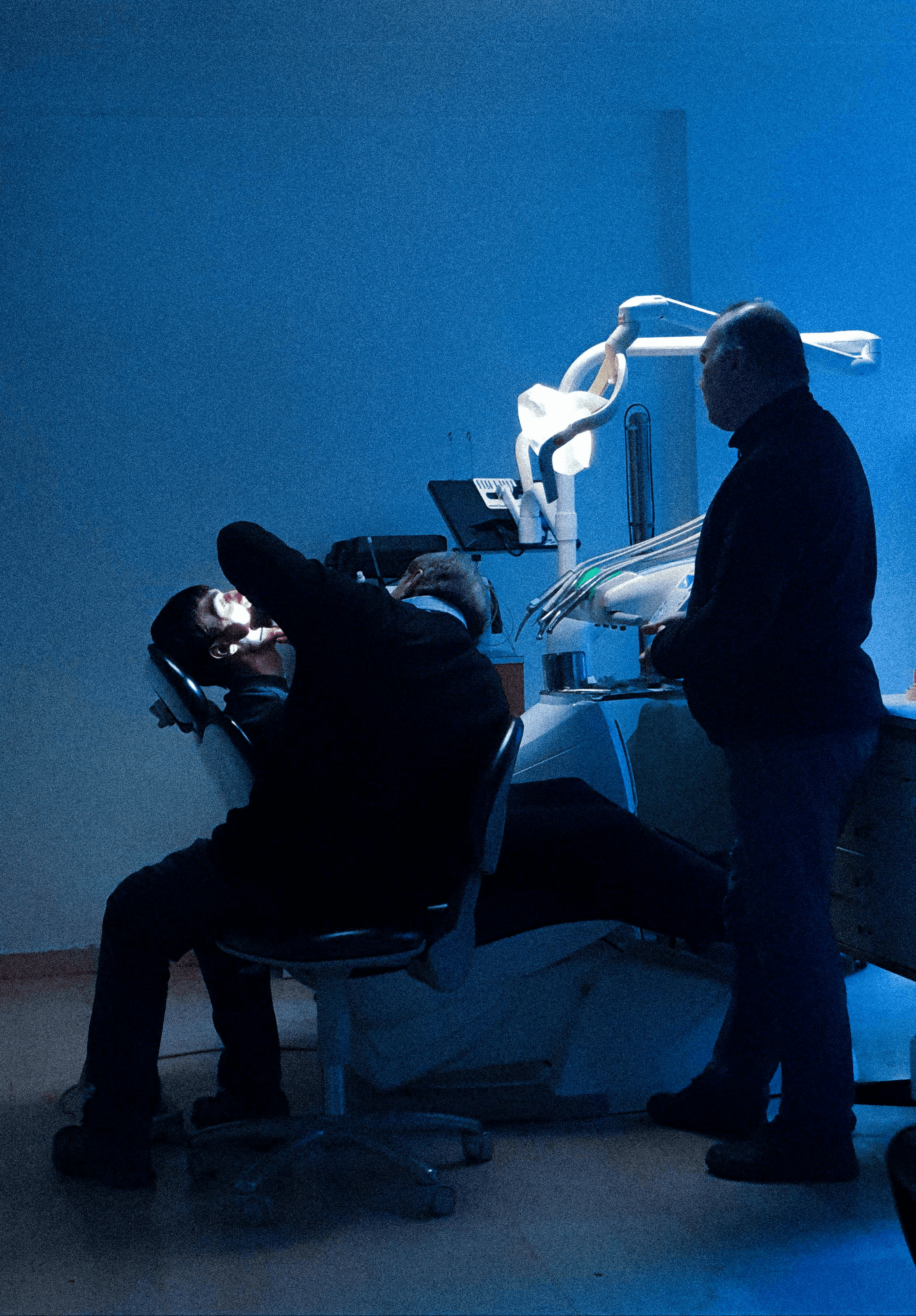Dentist treating a patient in his dental practice