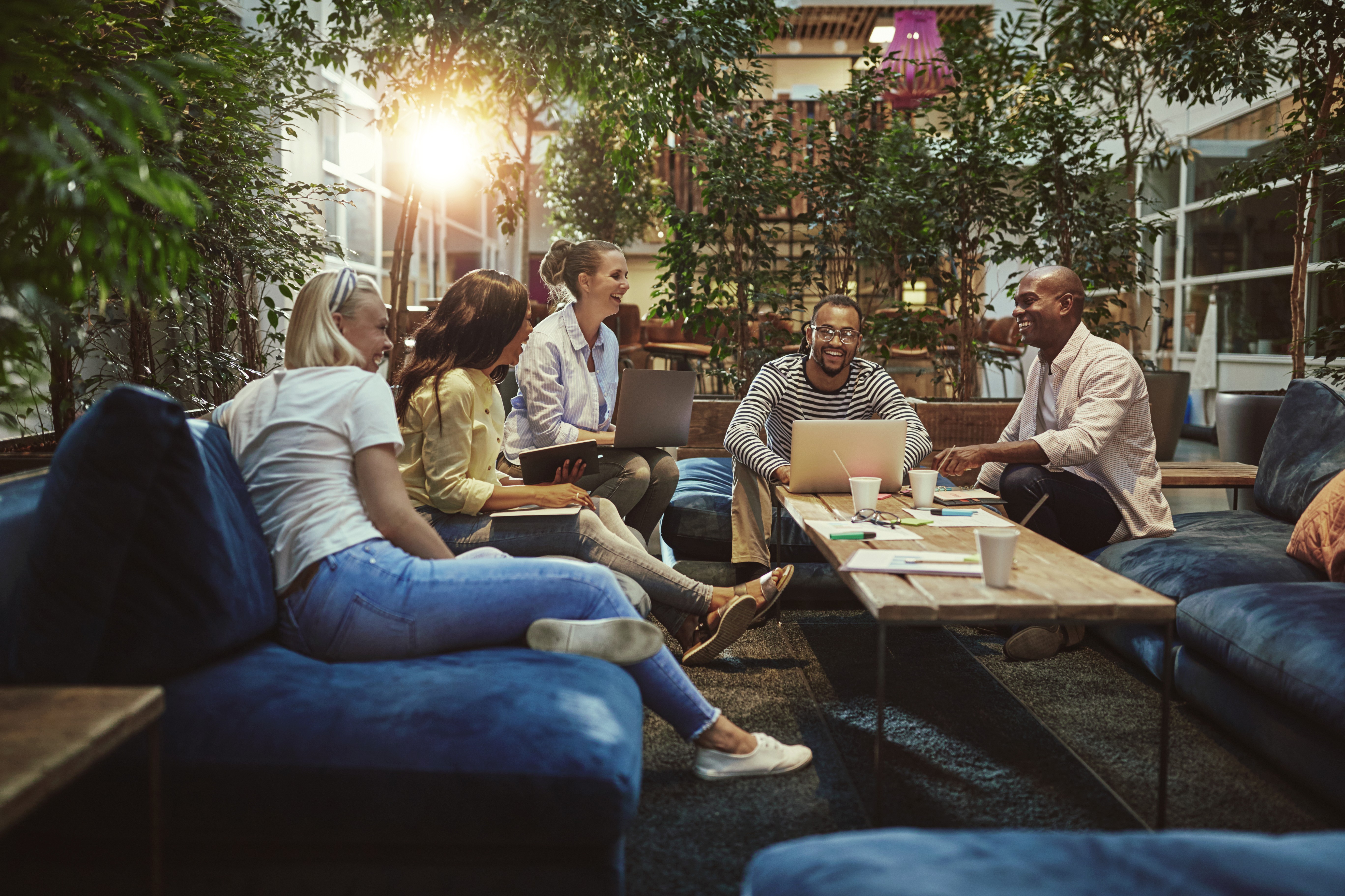 man wearing gray polo shirt beside dry-erase board