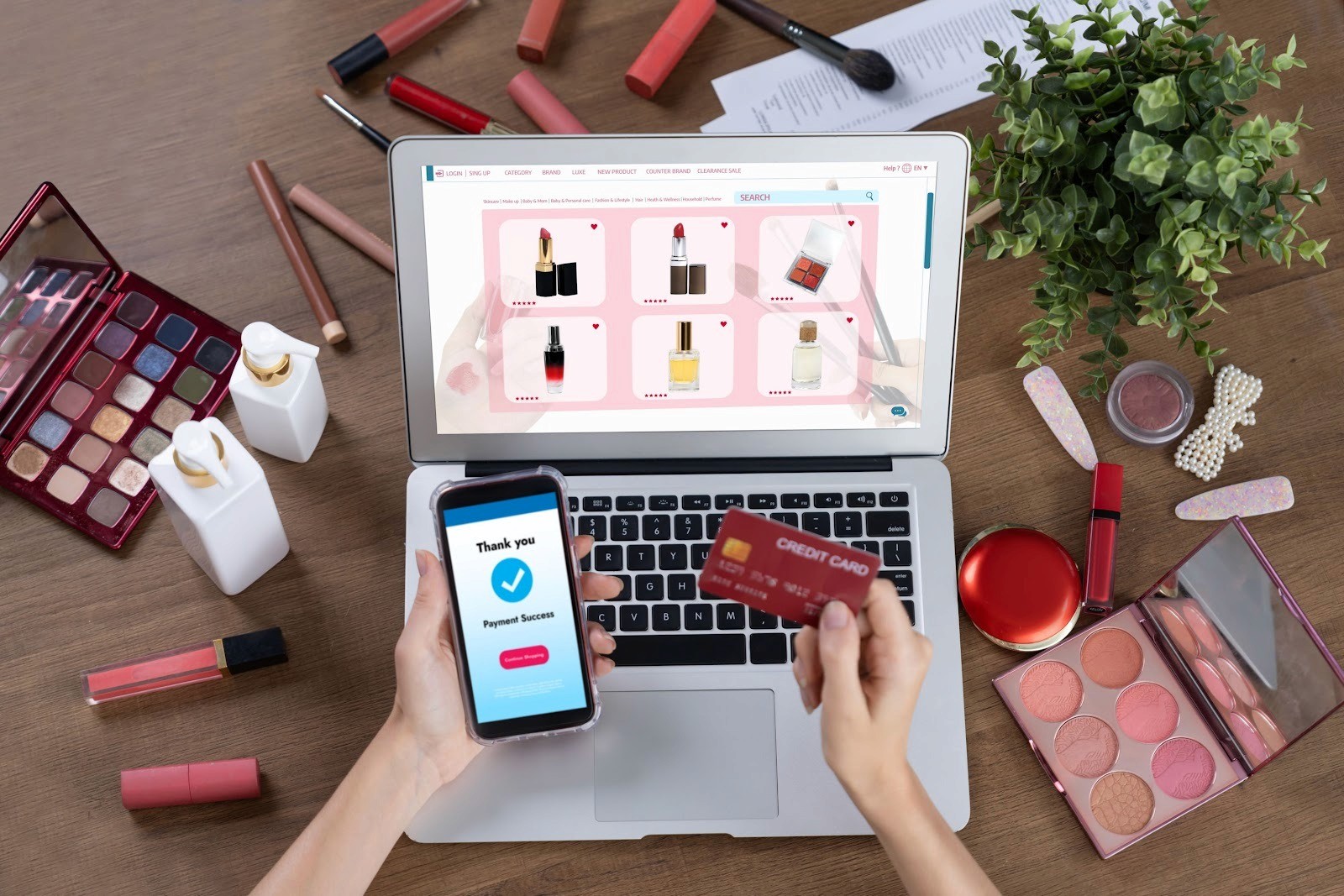 Online makeup shopping with laptop, phone, and credit card