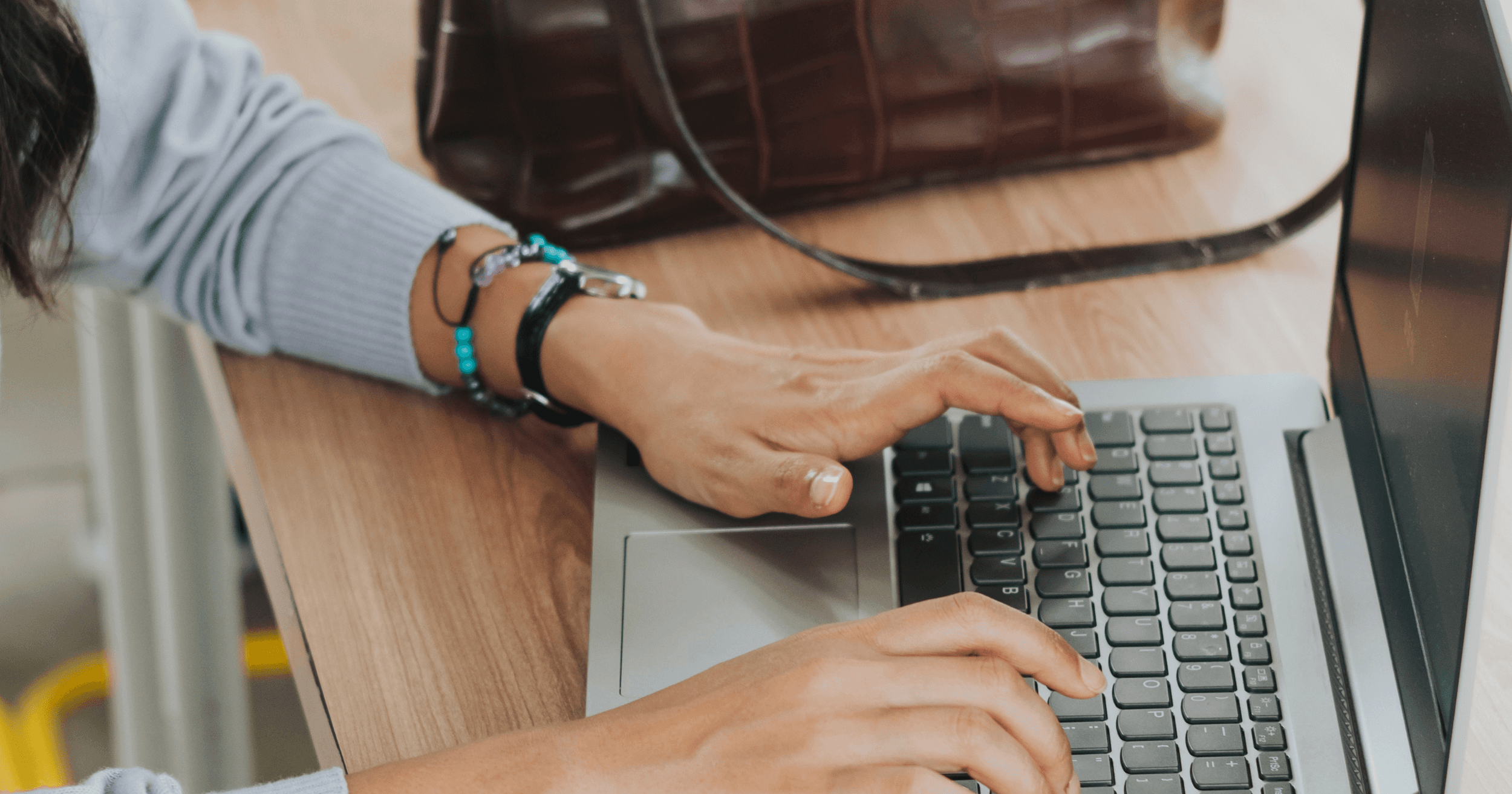 A Malaysian F&B staff typing on her laptop