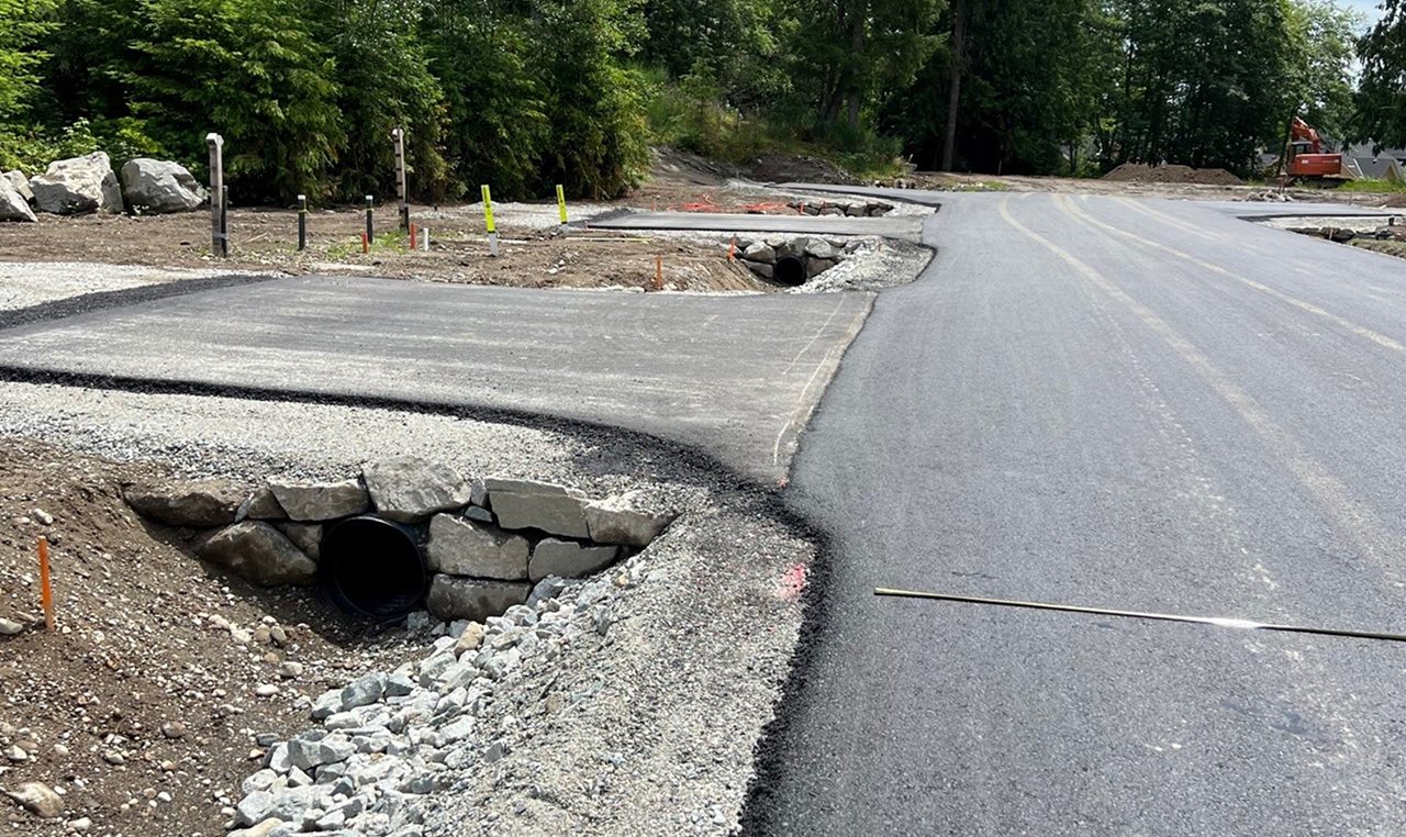 Roadway drainage culverts with riprap erosion protection during Castle Road subdivision construction