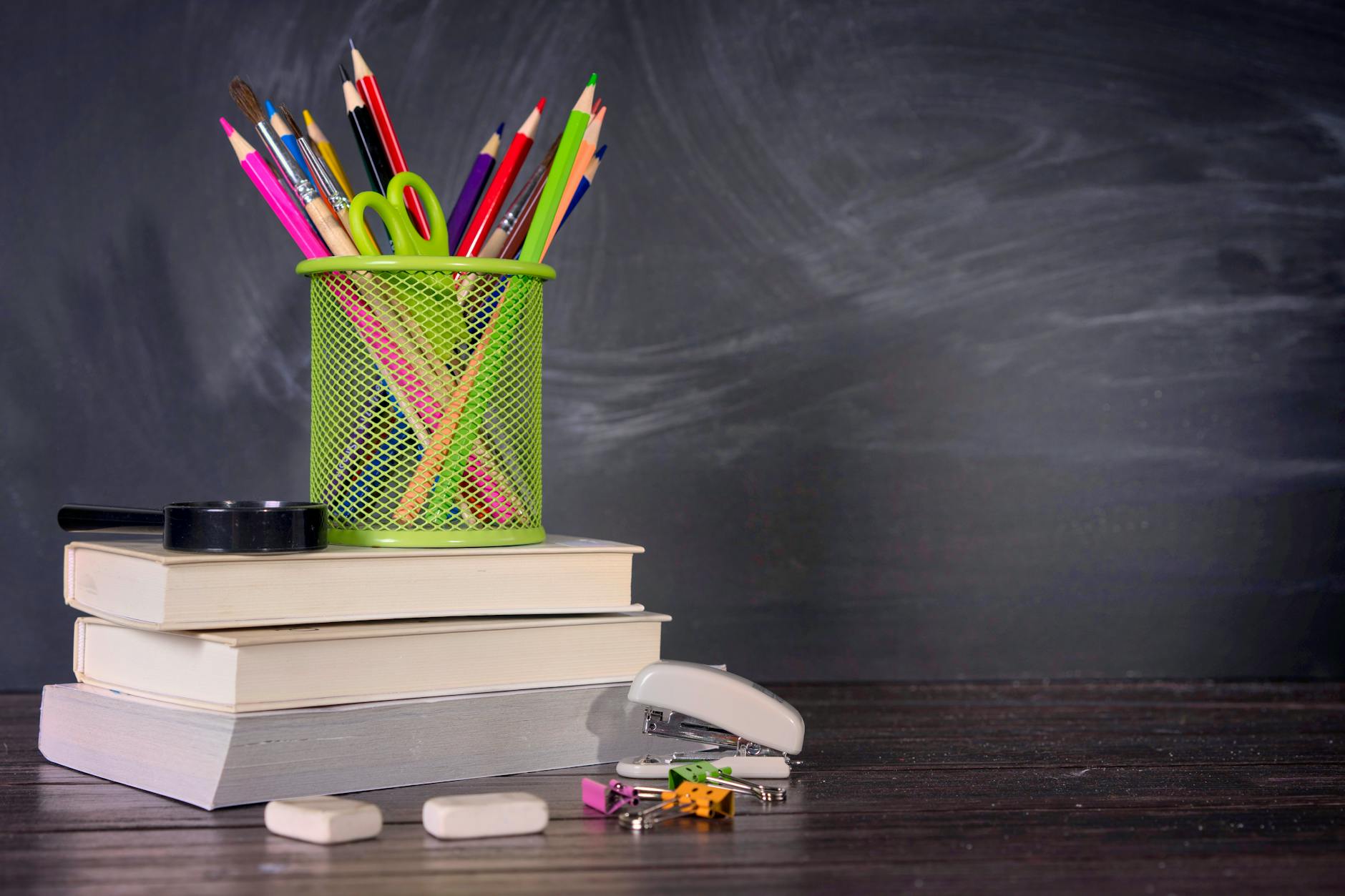 Close-up of diverse textbooks and open notebooks on a wooden table representing a new education policy for curriculum.