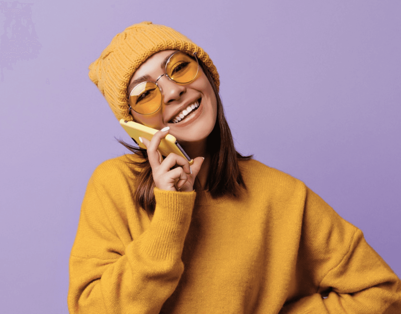 A woman in a yellow outfit handling a phone.