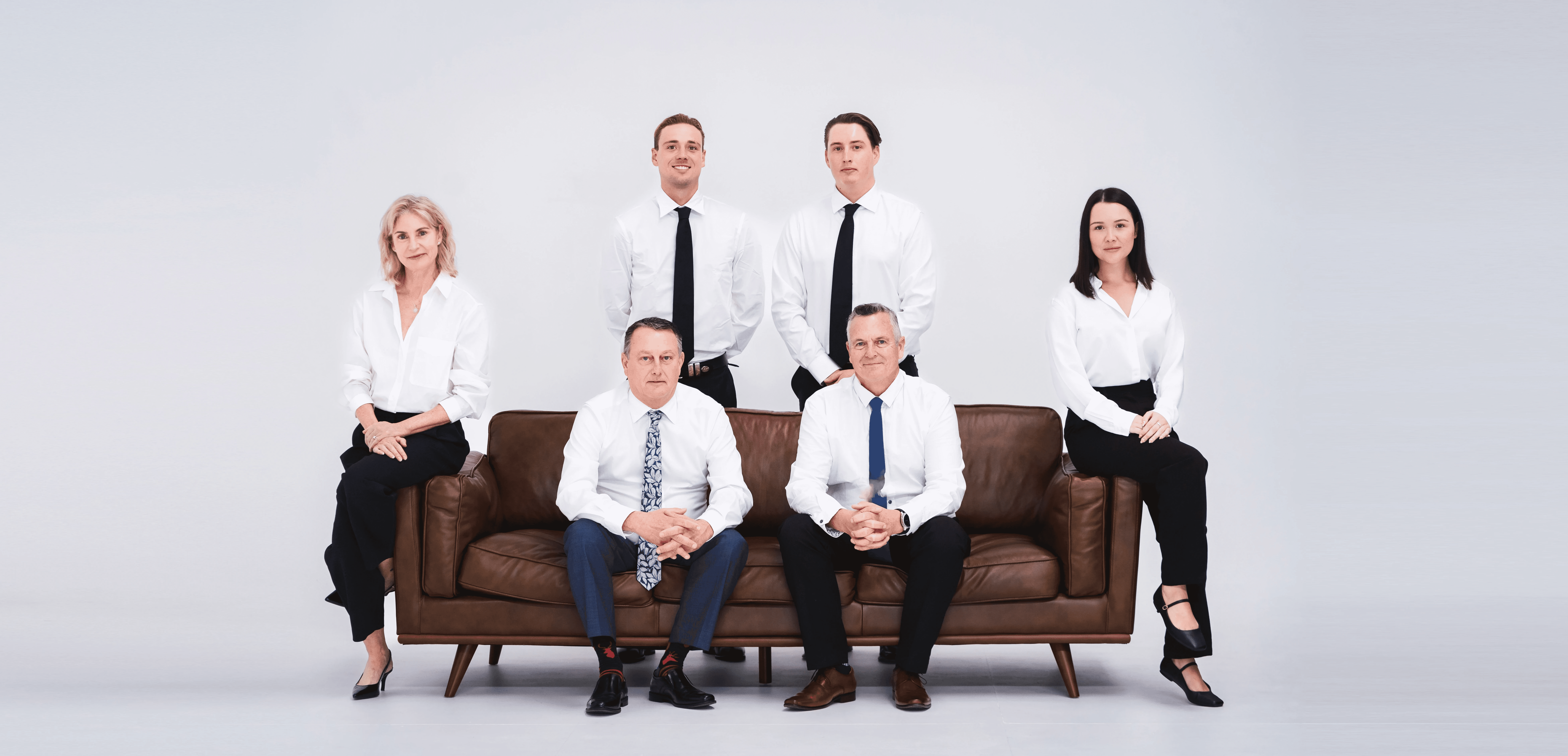 The team working together at a table with laptops, discussing business strategies or projects.