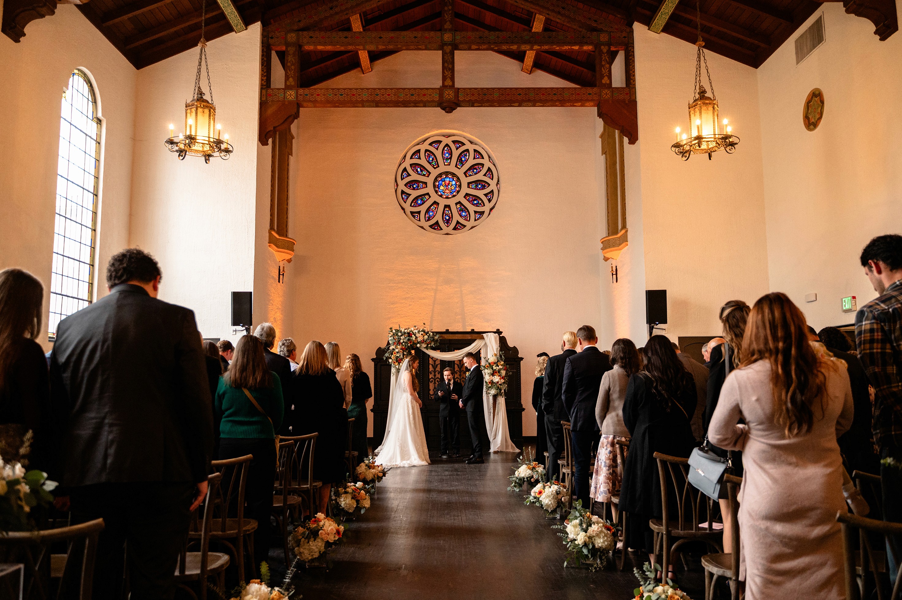 Flat lay wedding details with bouquet, rings, and sparkling bridal heels