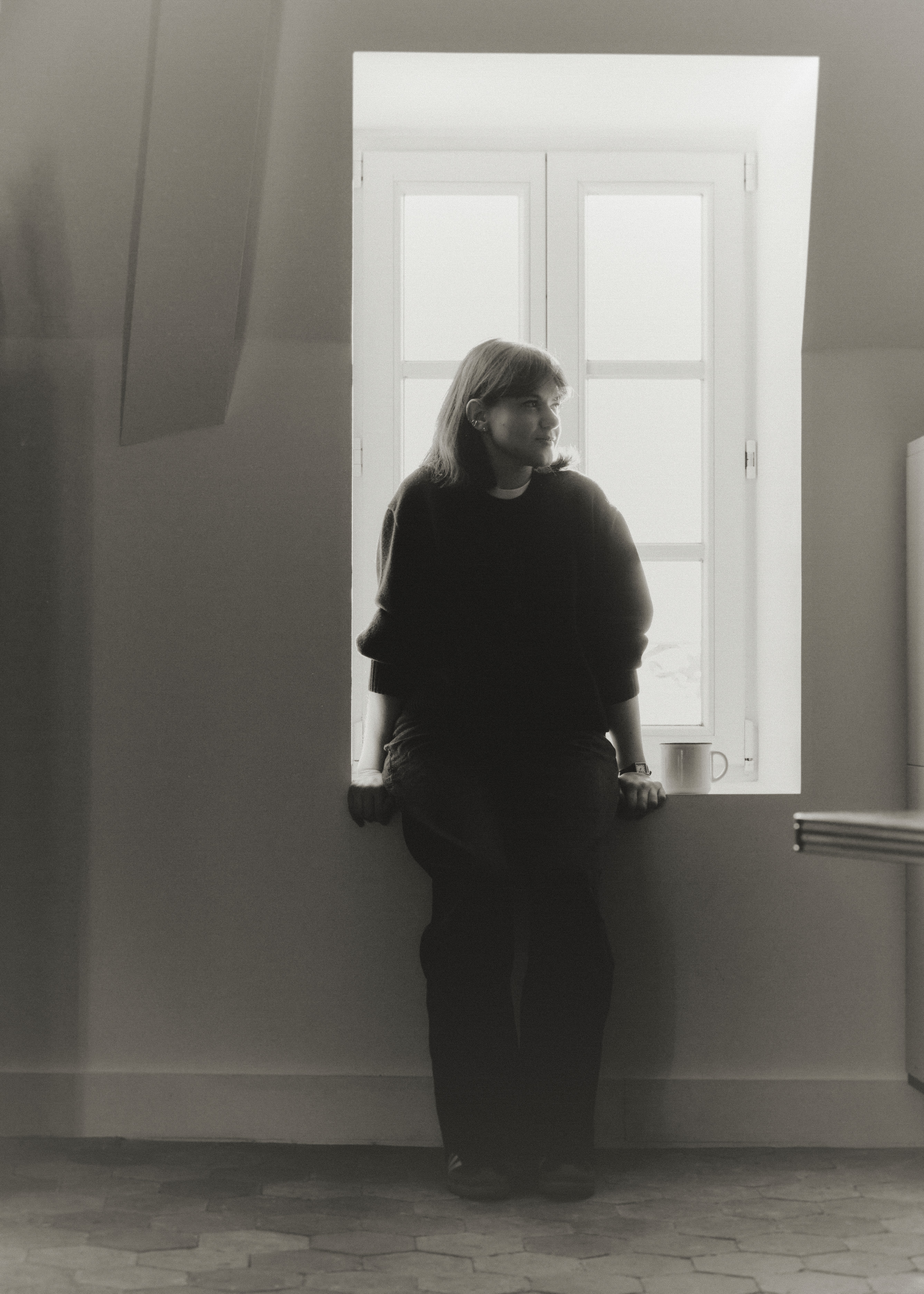 a blurry photo of a person standing in front of a wall