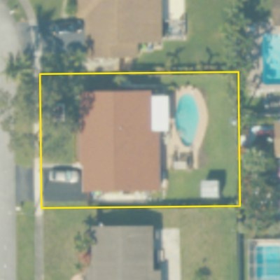 Aerial photo of a backyard pool in Fort Lauderdale, with the lot outlined in yellow