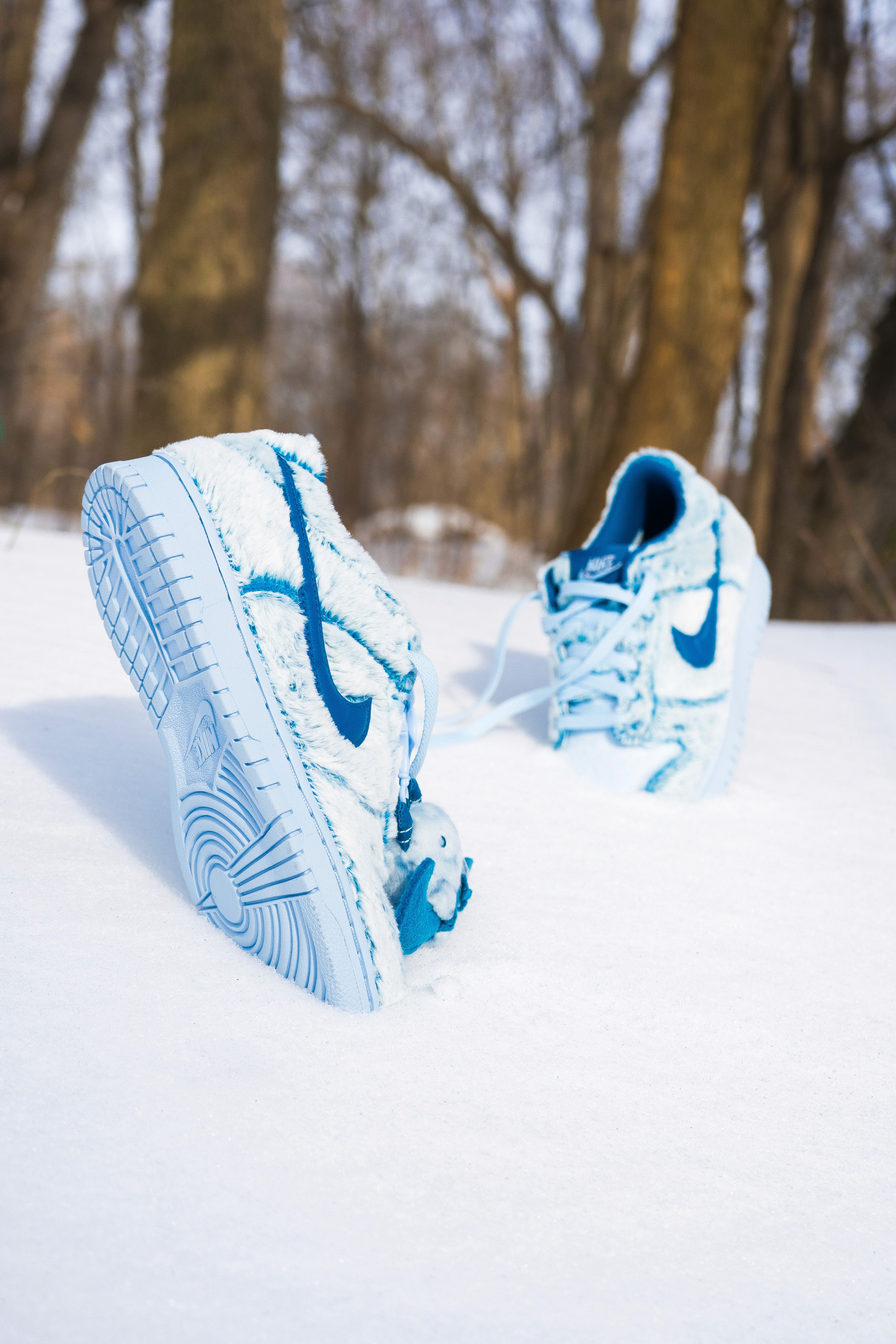 Close-up of a blue Nike sneaker sole in snow, captured for Nike x dotSWOOSH x Fortnite promotional content.