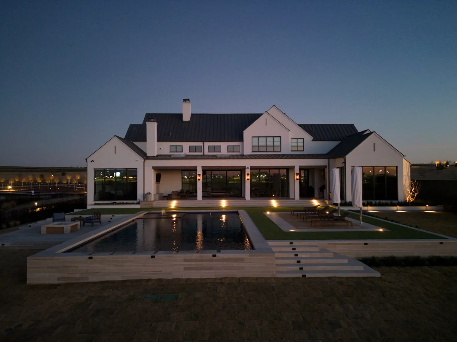 Full home view at golden hour of luxury landscape and home. Designed and built by Blount Designs and Alford Homes, Frisco TX