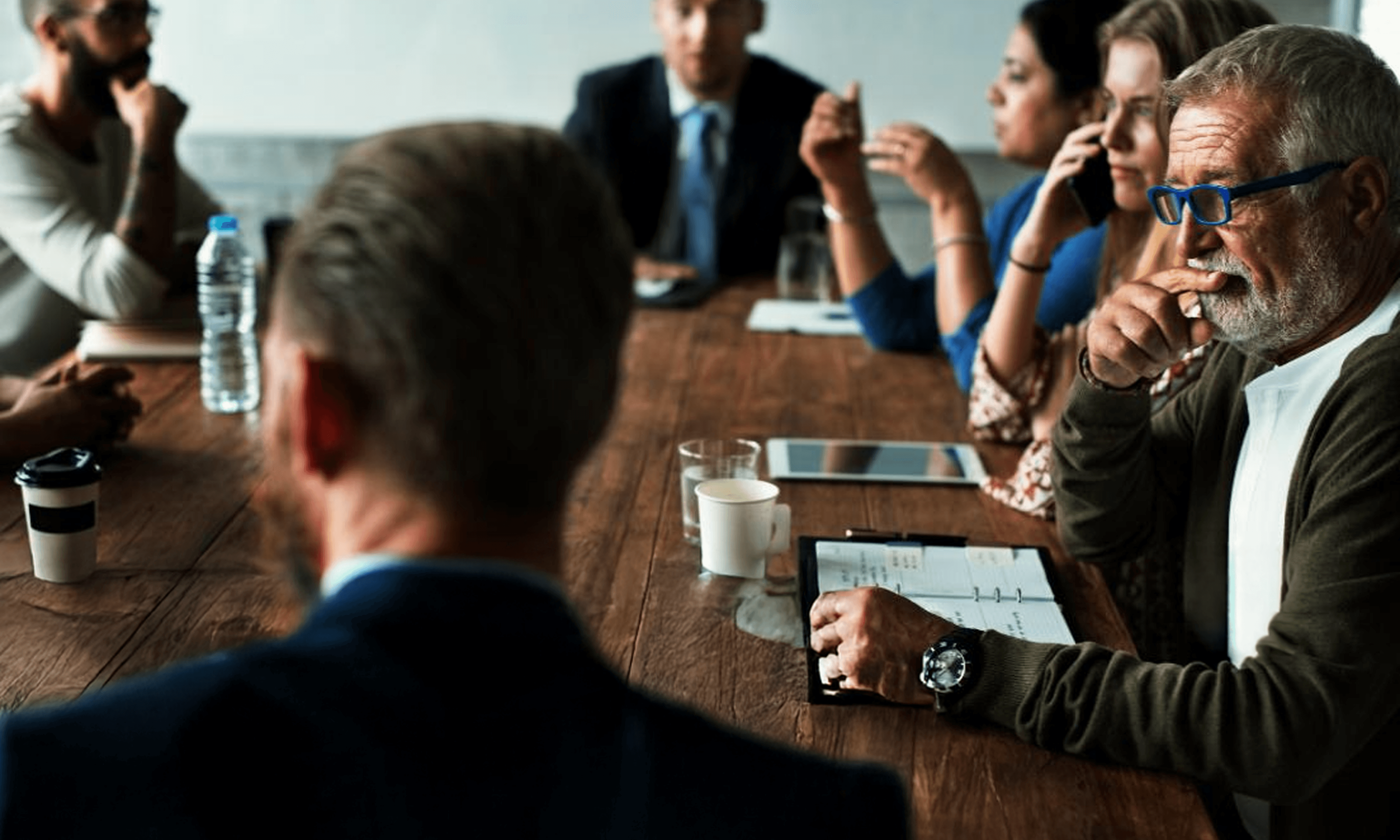 Business meeting with executives reviewing ideas and making decisions in a collaborative setting.