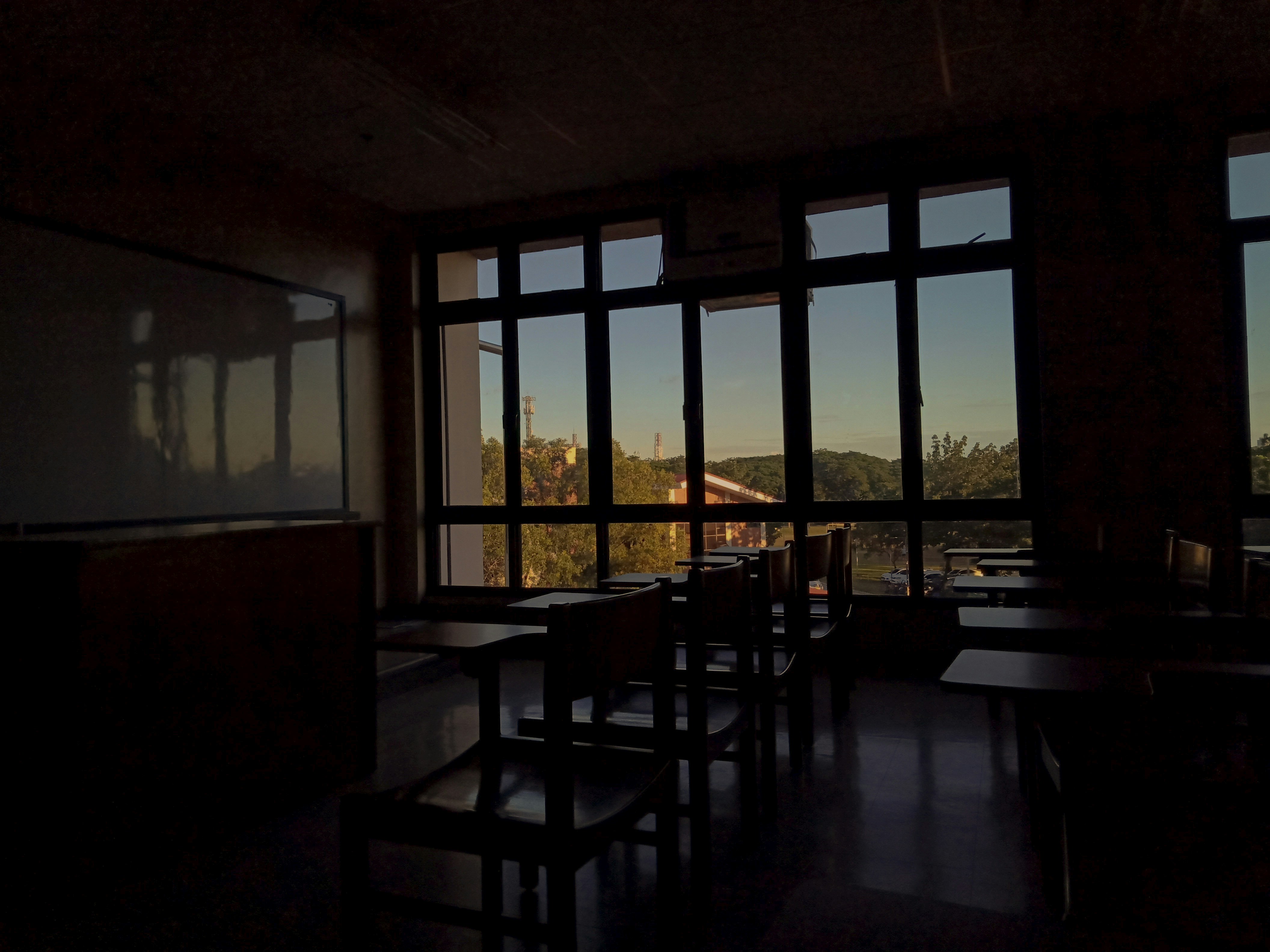 brown wooden table and chairs near window