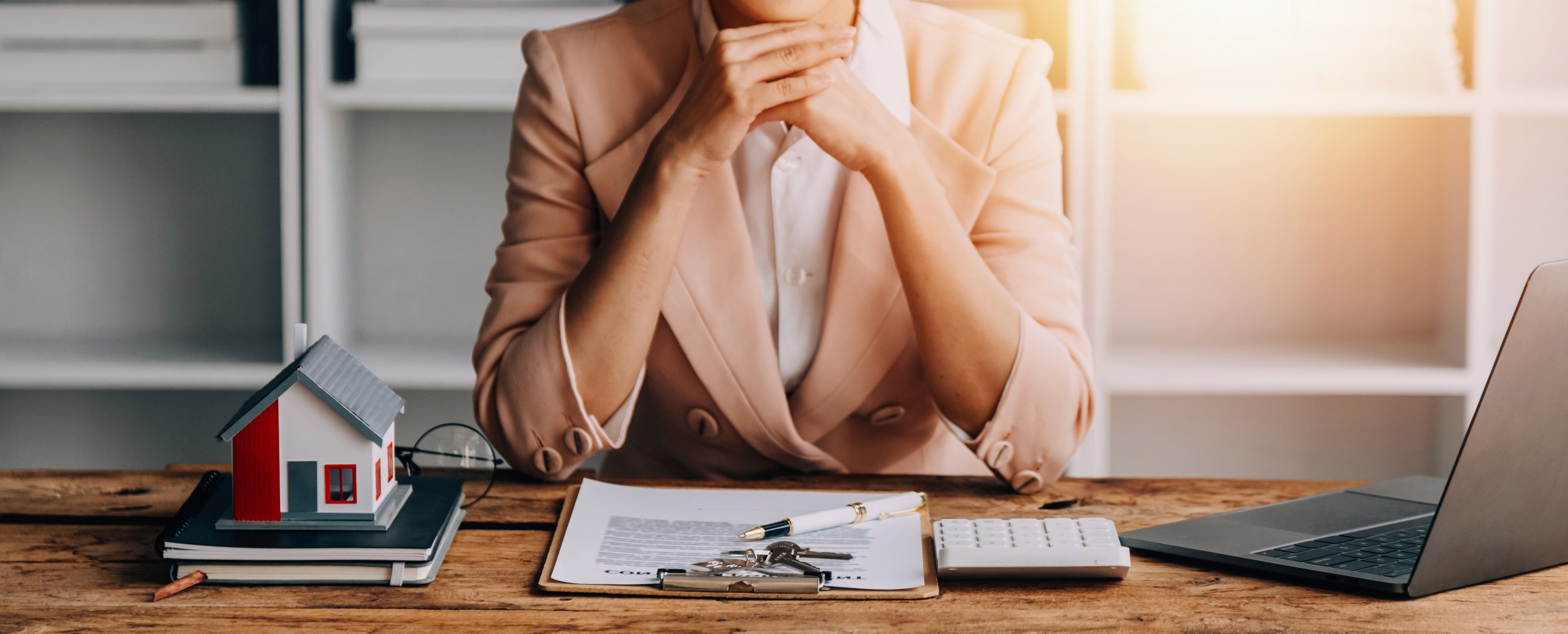 Two people working at desks in a bright, plant-filled office.