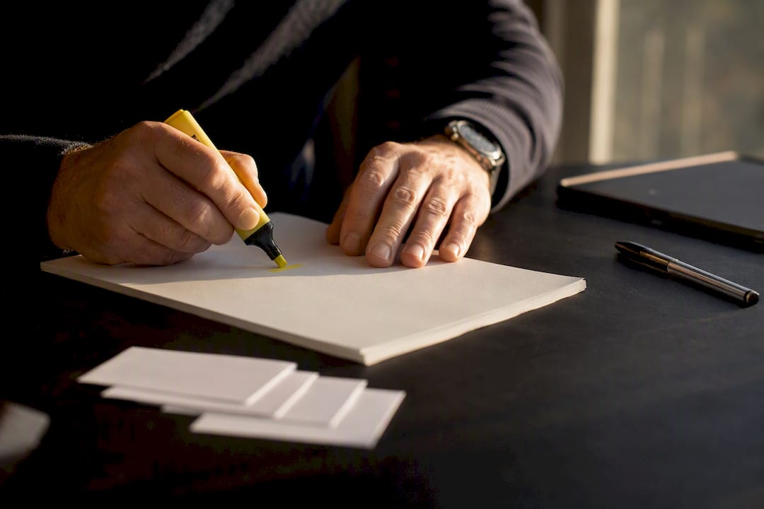 Hands highlighting prospects on desk