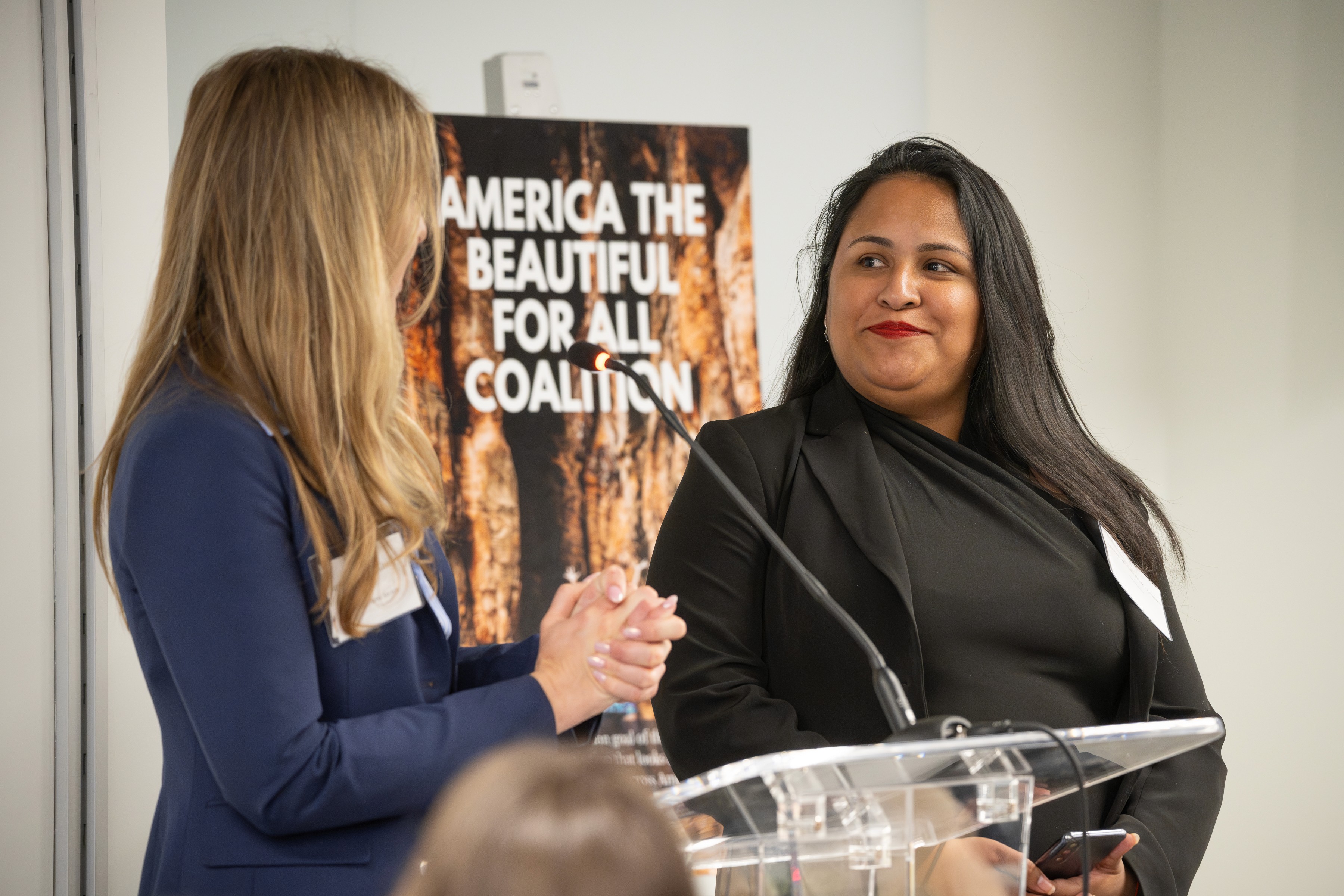 Two women in front of podium.