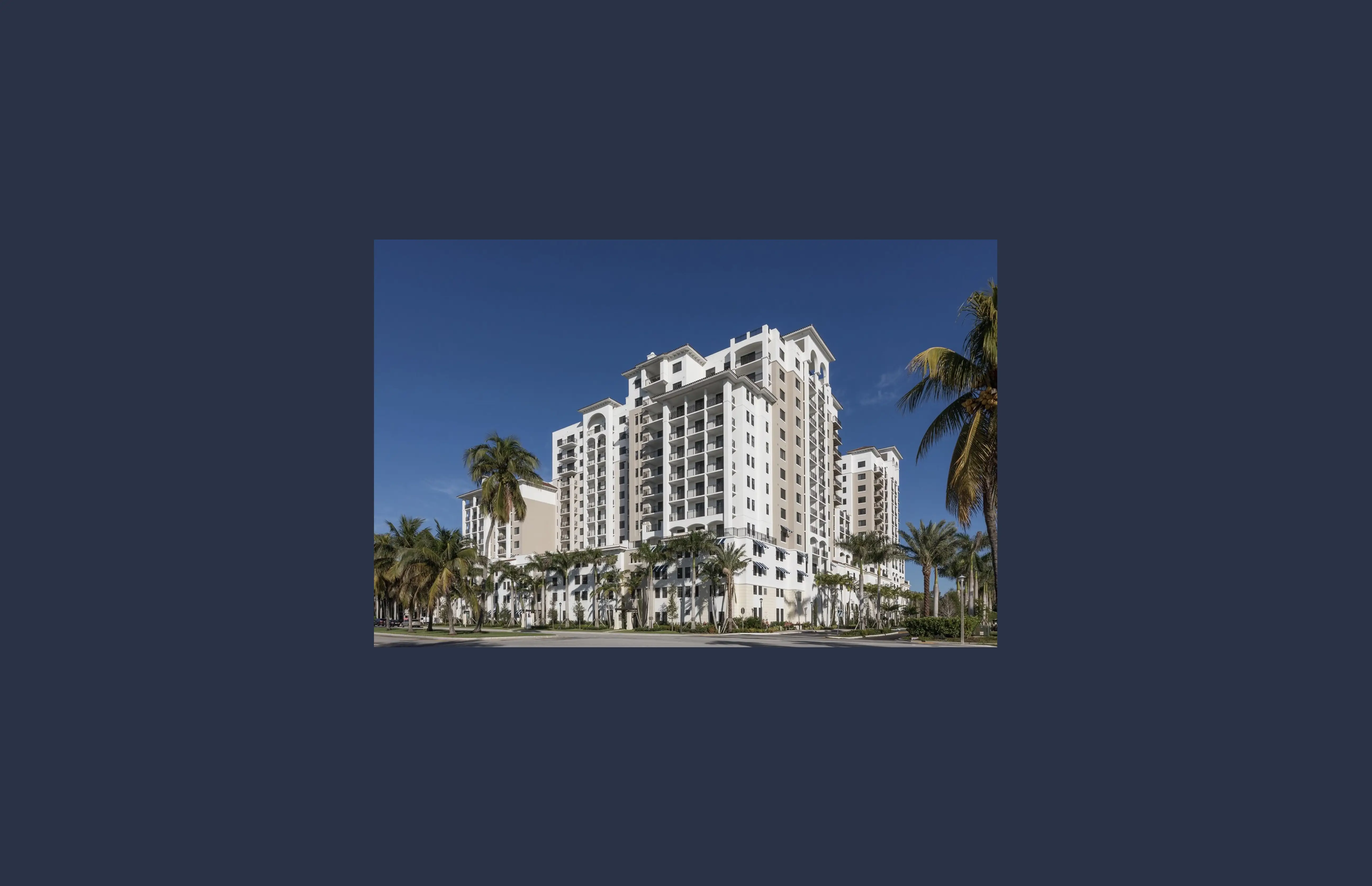 Luxury multifamily apartment building with palm trees, illustrative of Cardone Capital's real estate and bitcoin fund model