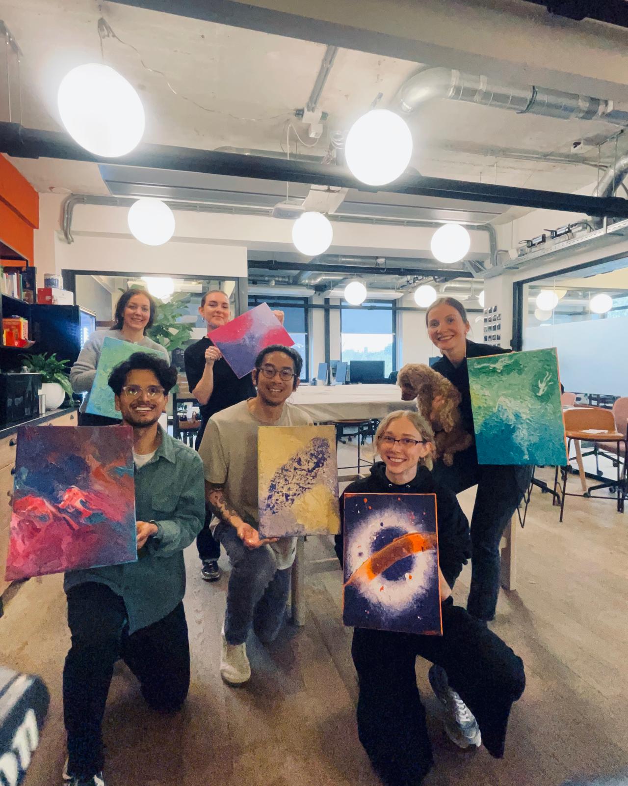 A winding road cuts through rocky terrain, surrounded by patches of green grass and illuminated by sunlight.