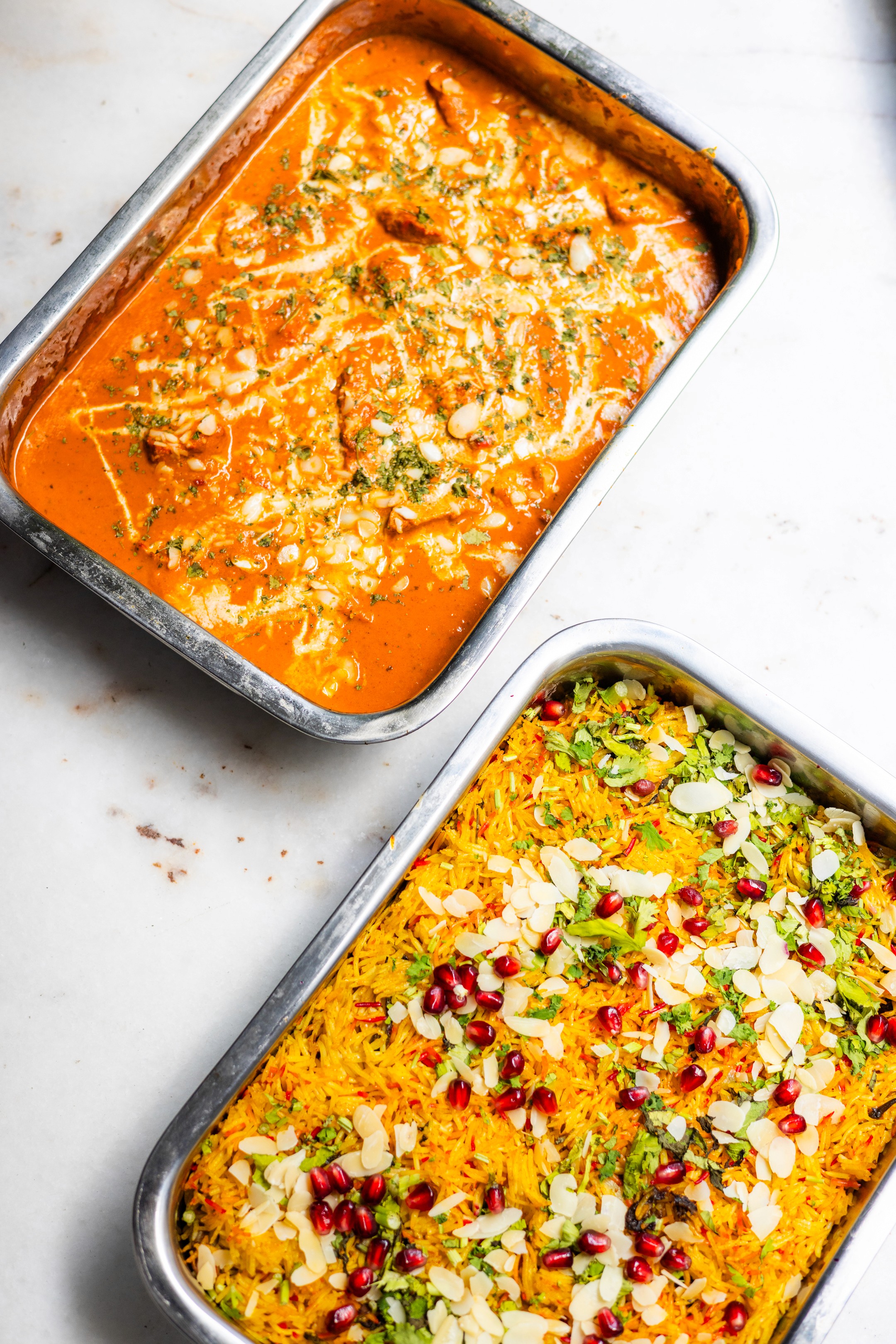 Two chefs behind the kitchen counter