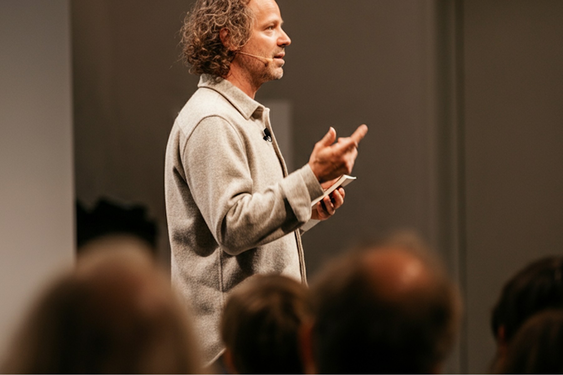 Man holding a lecture in front of a small audience