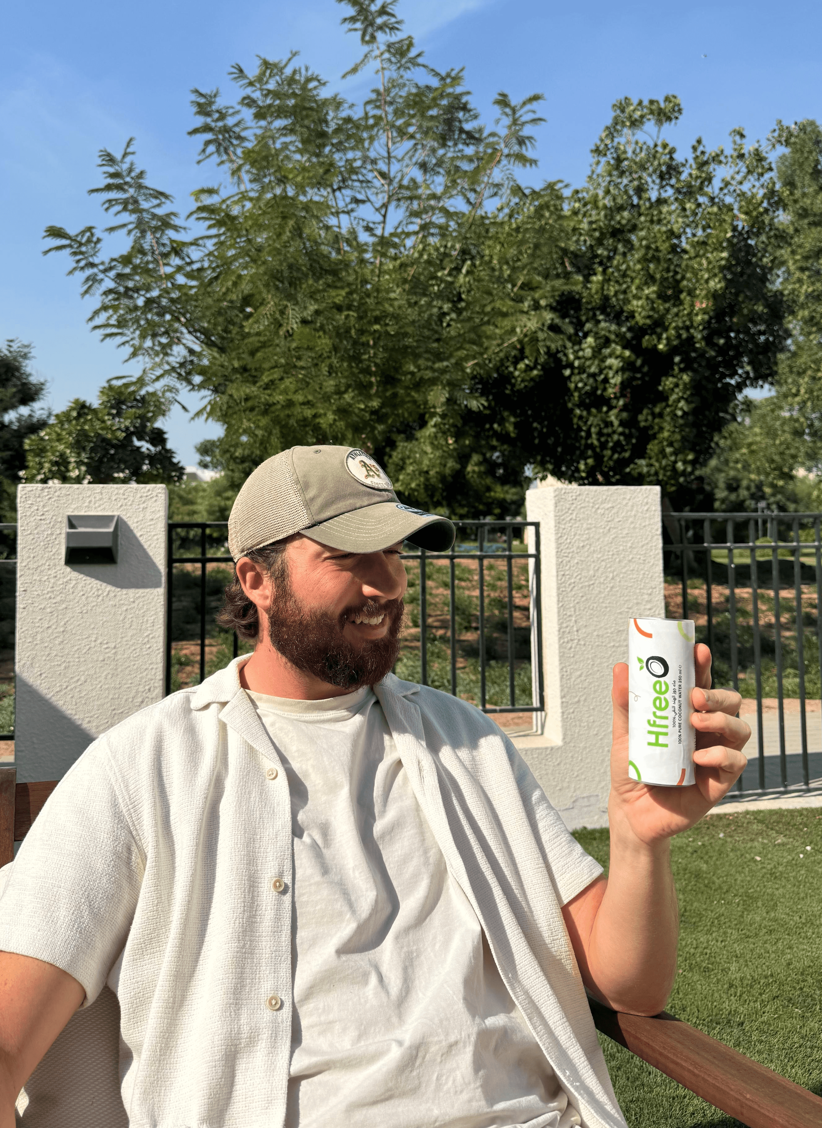 a man with a beard holding a can of beer