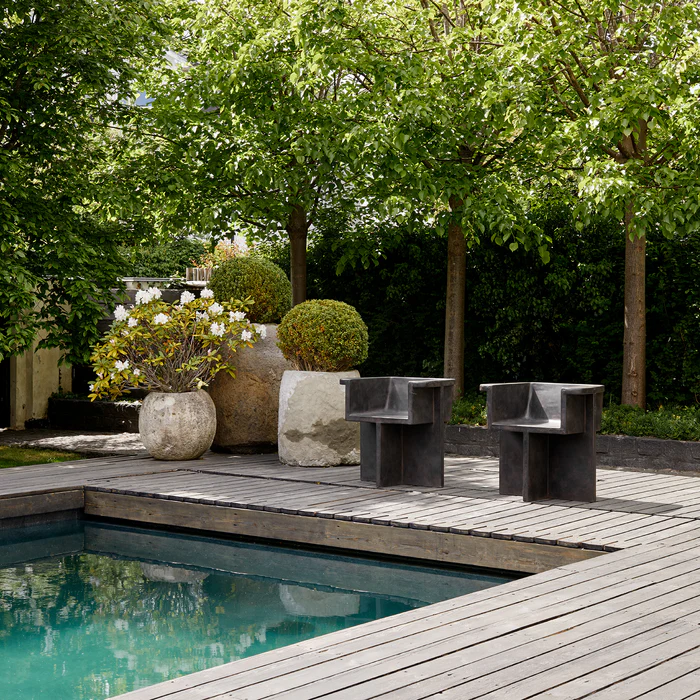 Terracotta workspace with custom wooden desk, warm plaster walls, natural light, and abstract wall art.