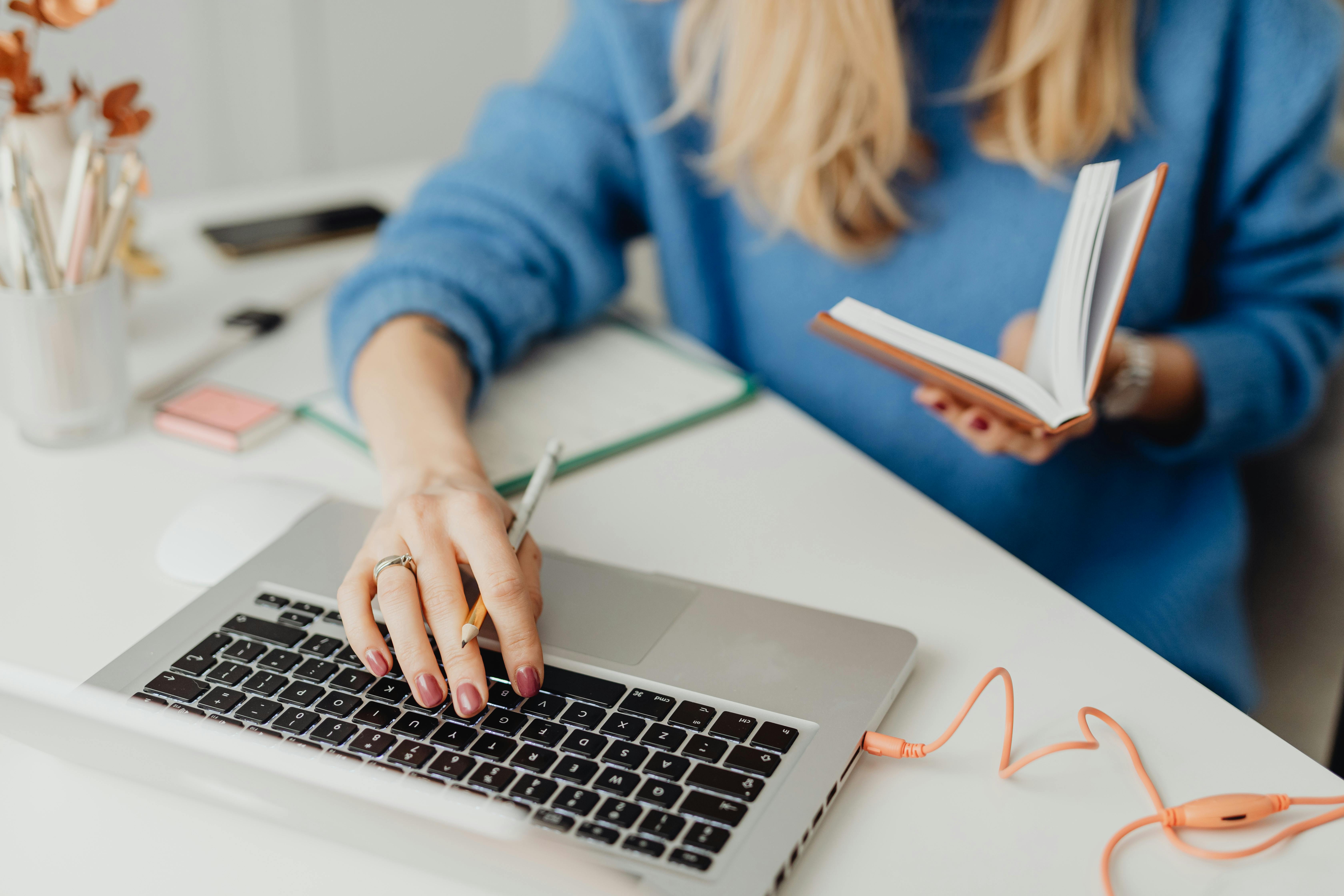 A lady in a blue jumper planning on a laptop