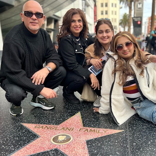 A Hollywood Walk of Fame area Tourist is happy with their own replica star personalized for a photo.#group