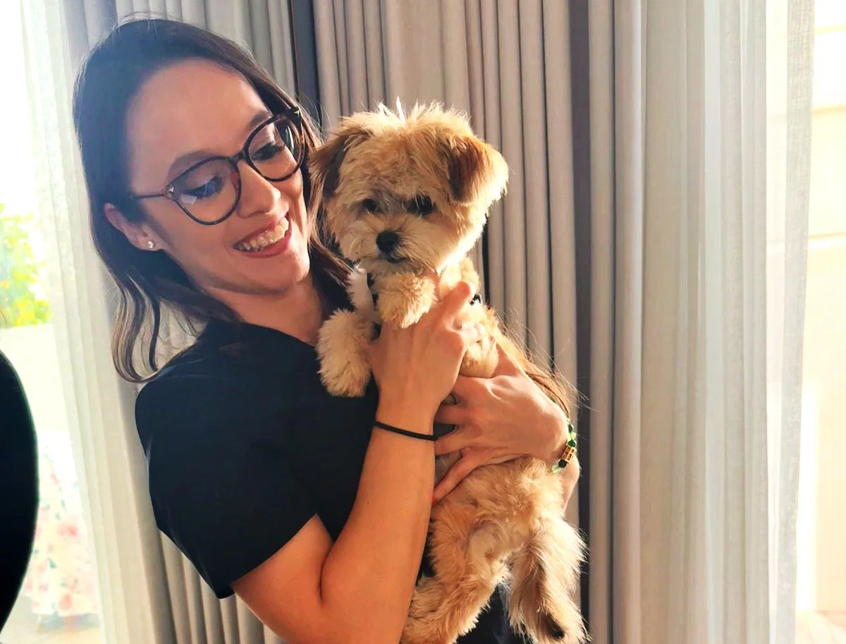 A mobile vet is taking care of a dog inside the owner's home.