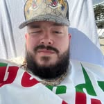 Man with short blonde hair wearing tank top