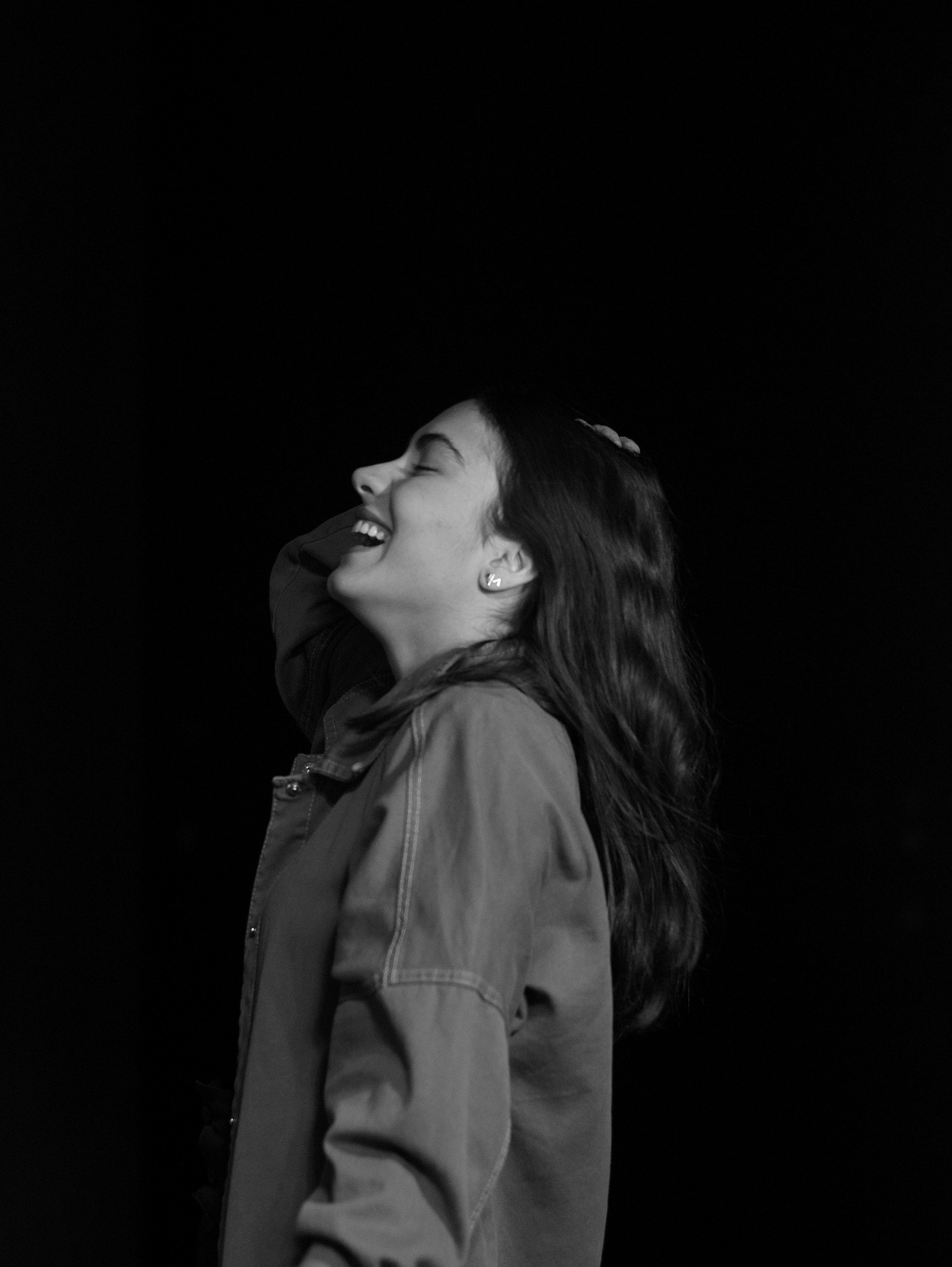 a woman standing in the dark with her mouth open