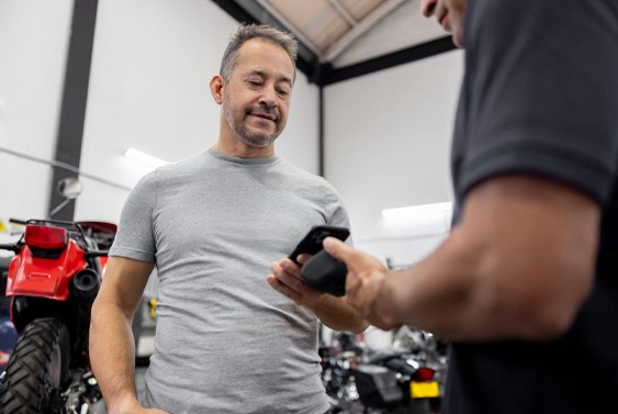 happy customer pays for new motorcycle keys