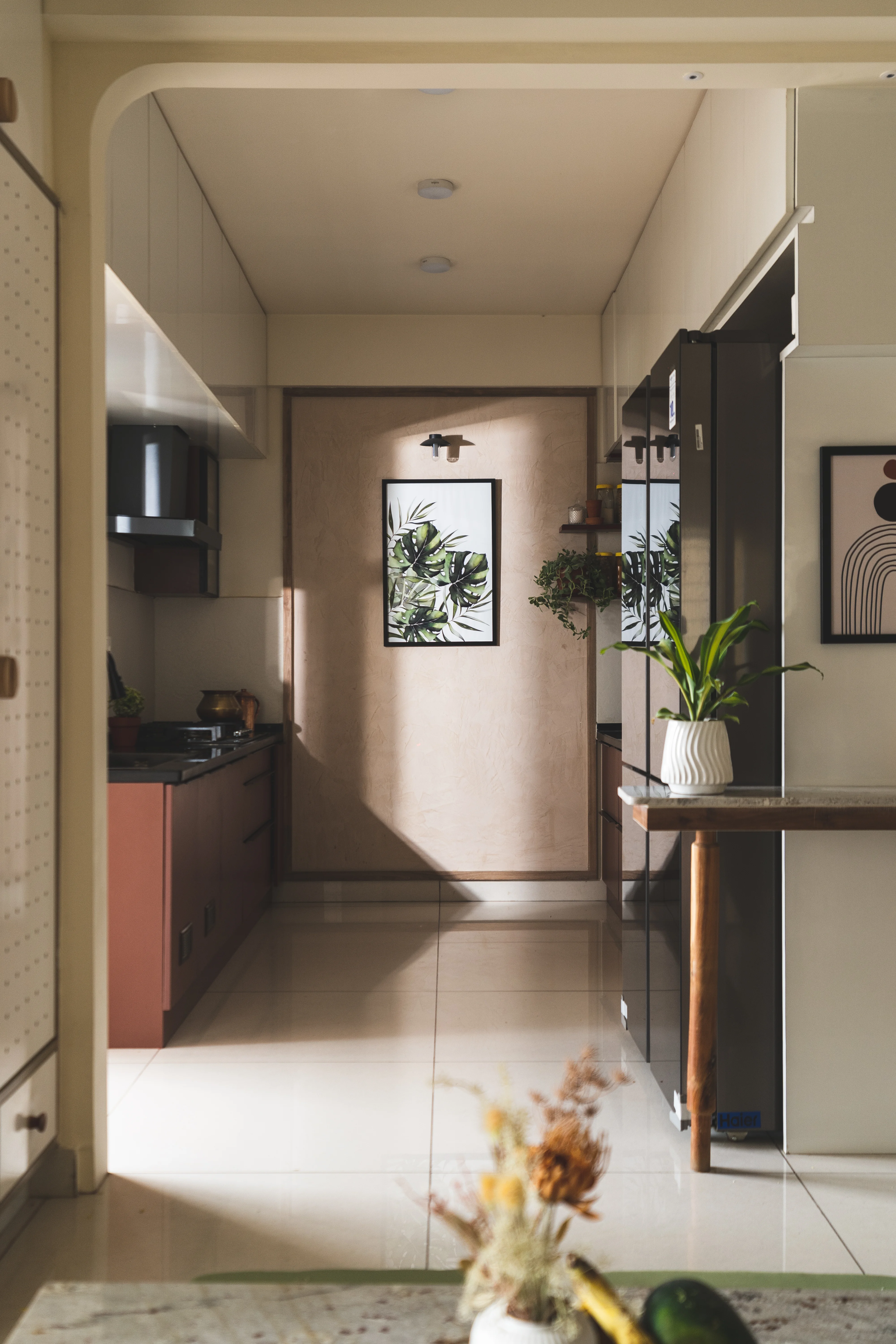 A modern kitchen featuring a curved table and chairs, designed for aesthetic appeal in South Indian homes.