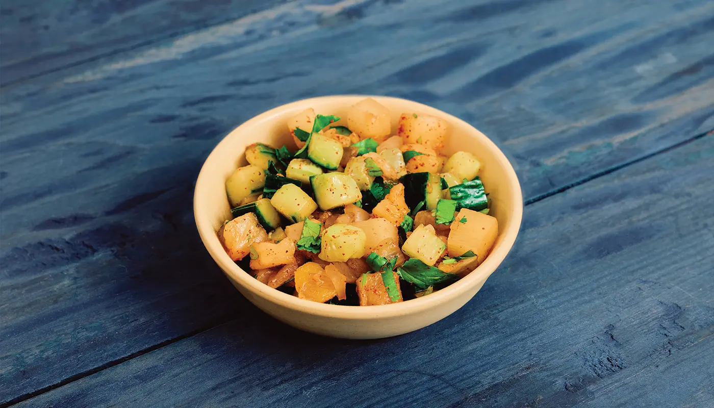 Pineapple Chow in a bowl on blue wooden boards.