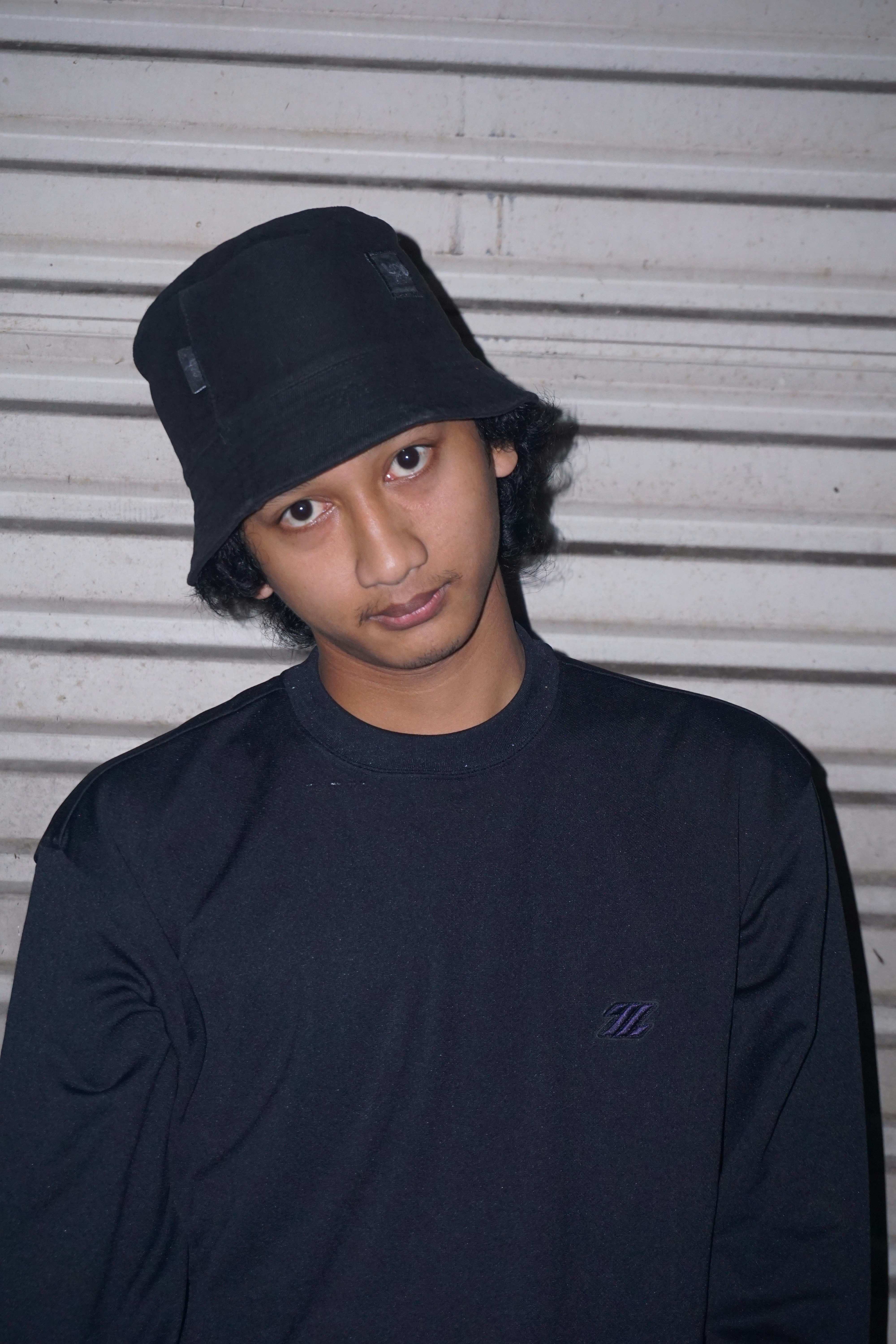 woman in black crew neck shirt wearing black cap