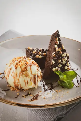 Elegant plated dessert with chocolate elements and decorative garnish