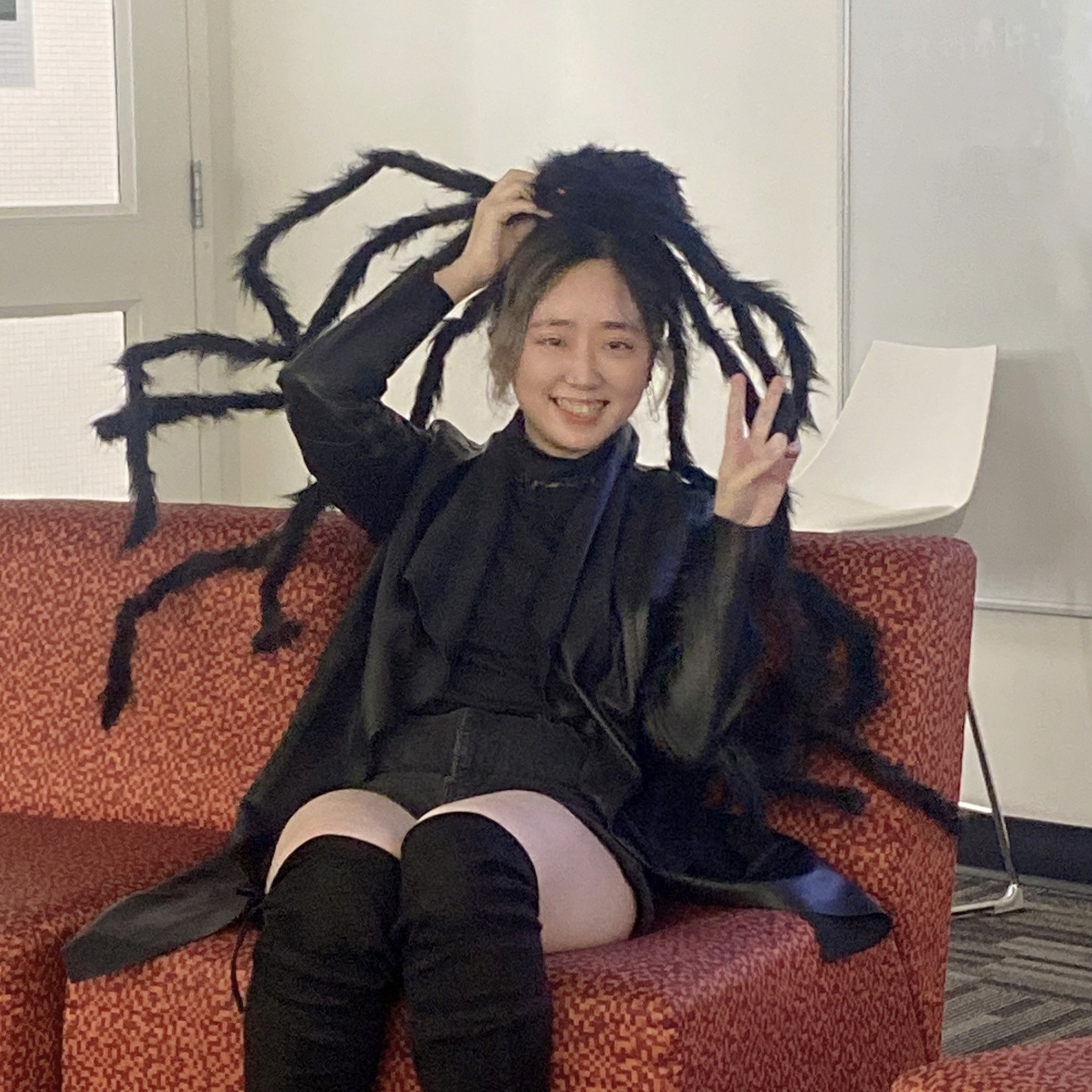 Portrait of a person in dark clothing speaking on a phone