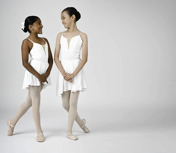 2 friends in ballet costumes during a professional photo shoot