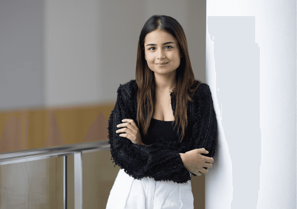 Close-up of lush, dark green leaves, some glossy and wet, against a muted background.