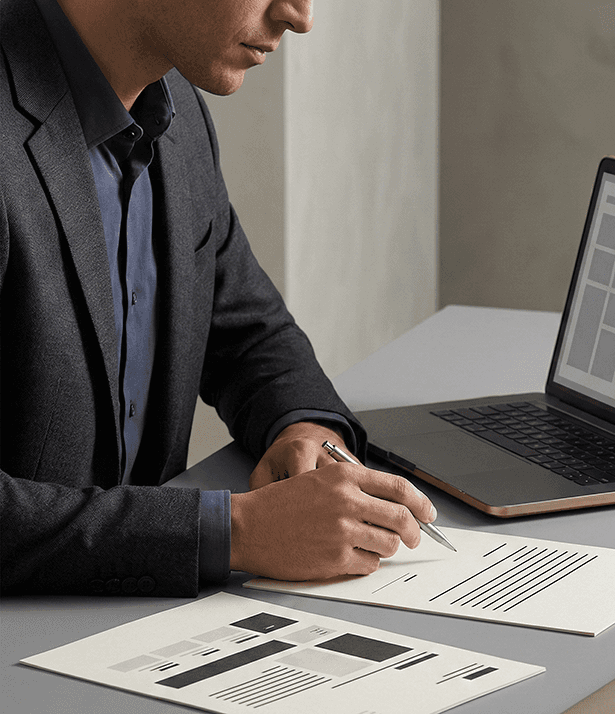 three men laughing while looking in the laptop inside room