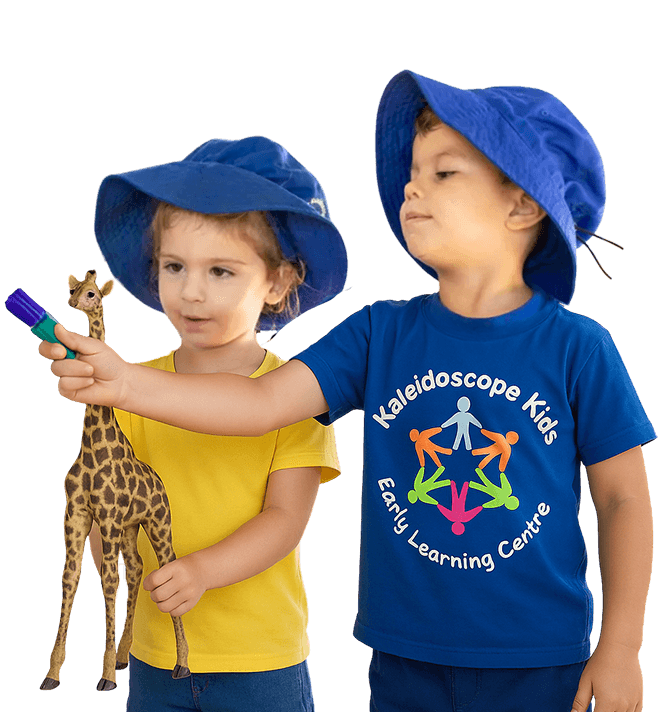 Two children in blue and yellow Kaleidoscope Kids uniforms playing during a kindergarten activity