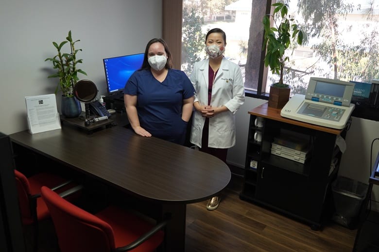 Doctor checking a male patient's hearing