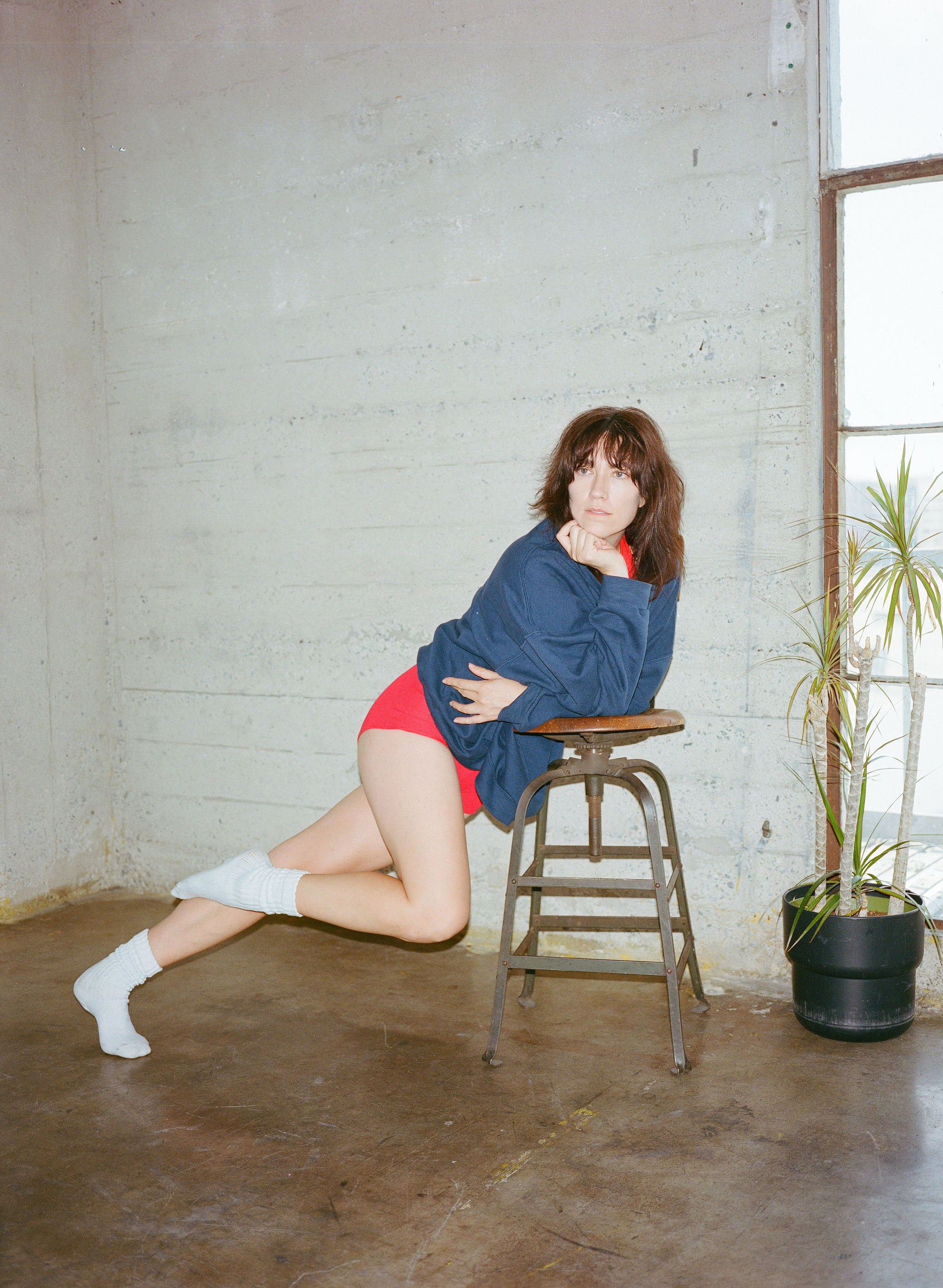 Woman with red hair covering mouth with hair